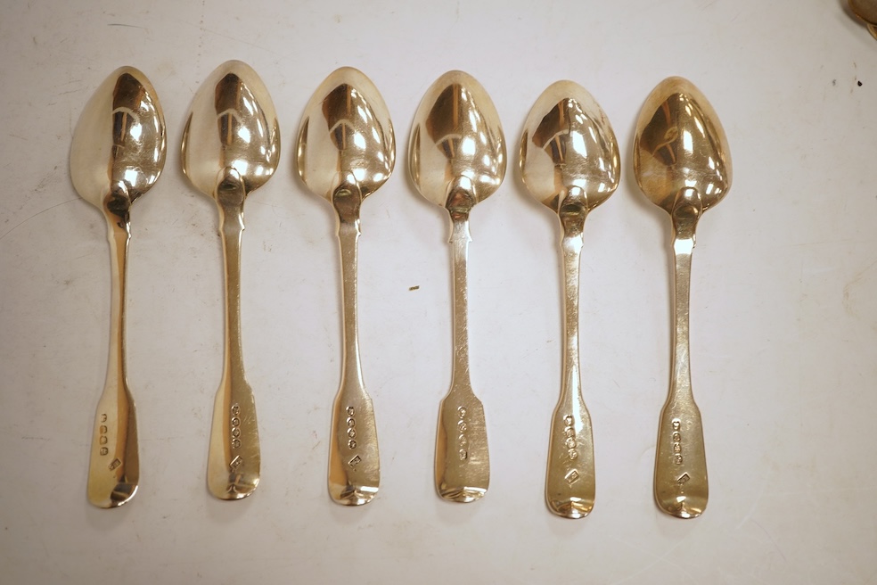 A matched set of six George III silver fiddle pattern dessert spoons, including five by William Eaton, London, 1815, 8oz.